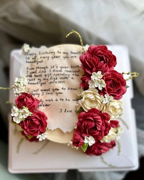 Buttercream floral cake with edible love letter